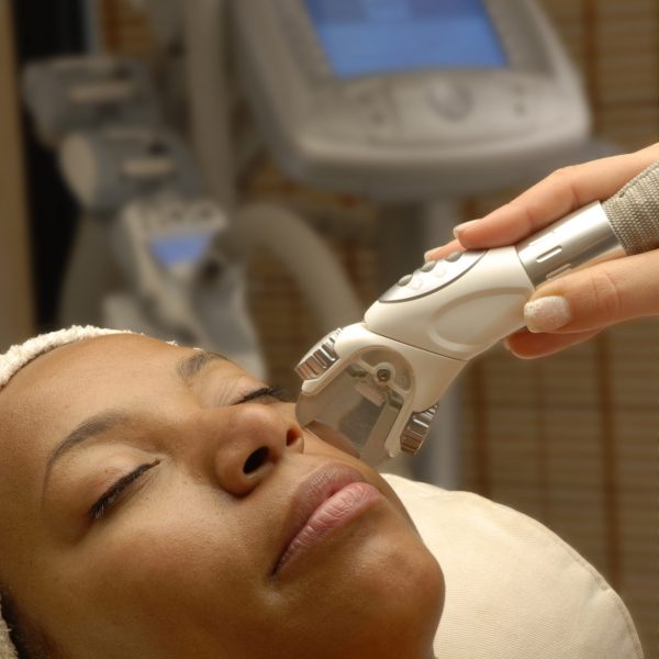 Young,Afro,American,Woman,Getting,Ultrasonic,And,Laser,Face,Treatment